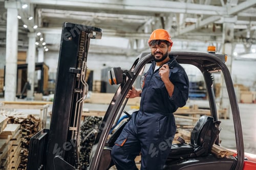 Preview: Forklift, machinery to help. Portrait of a male carpenter posing in a woodworking workshop