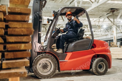 Preview: Warehouse worker operating a forklift while handling wooden materials