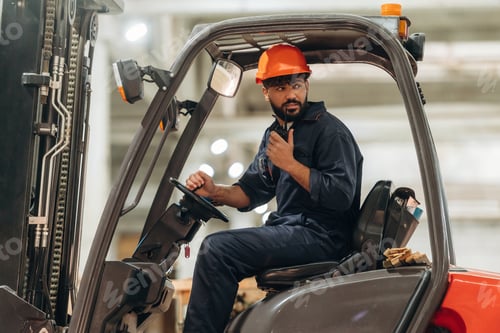 Preview: Ready to load. Warehouse worker operating a forklift while handling wooden materials
