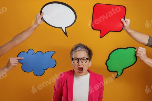 Preview: Woman with short gray hair in pink blazer is expressing frustration while surrounded by colorful spe