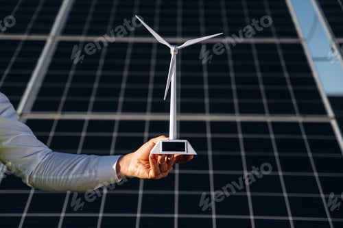 Preview: Male solar engineer examining photovoltaic panels at a power station