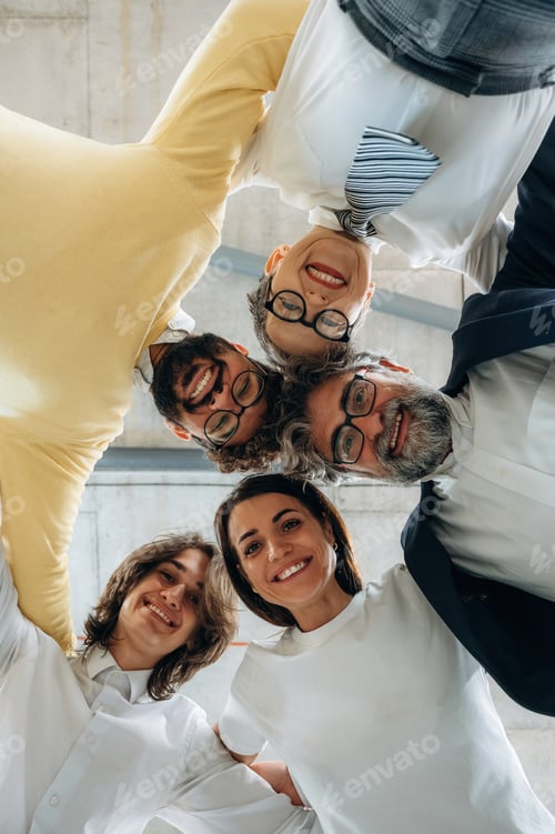 Preview: Group of diverse business professionals smiling and posing together in a modern office setting, show