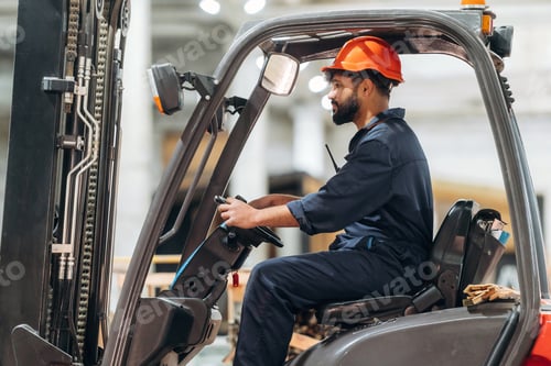 Preview: Driving, skilled employee. Warehouse worker operating a forklift while handling wooden materials