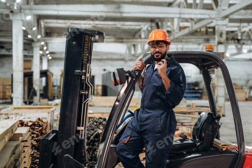 Preview: Forklift, machinery to help. Portrait of a male carpenter posing in a woodworking workshop