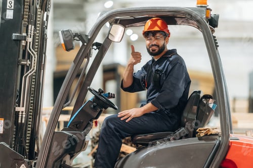 Preview: Ready to load. Warehouse worker operating a forklift while handling wooden materials