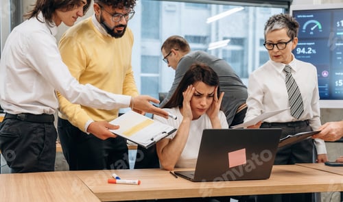 Preview: Group of diverse business professionals collaborating in a modern office, with one woman showing sig
