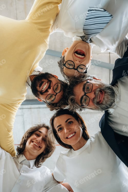 Preview: Group of diverse professionals smiling and posing together in a modern office environment, showcasin