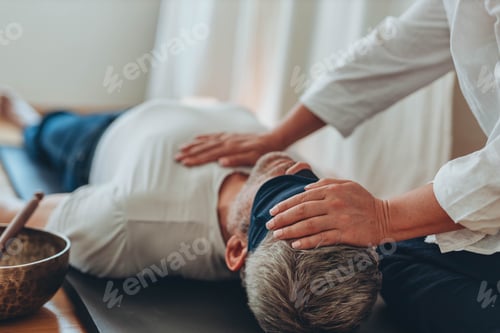 Preview: A man lying on a mat with a blindfold, practicing breathing exercises while a woman acts as a coa...