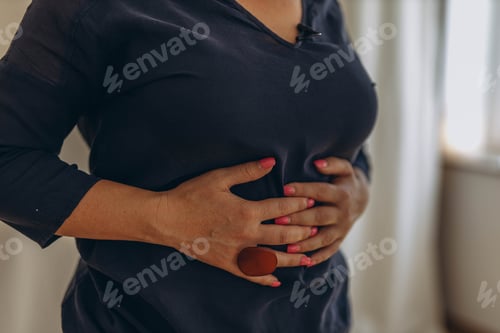Preview: A woman places her hands on her stomach, performing external techniques as part of chiropractic d...