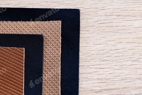 Preview: Collection of Black Tan and Brown Leather Texture Samples on Wooden Background