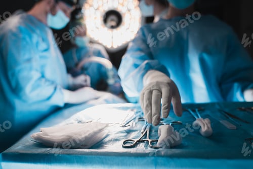Preview: Close up of assistant hand reaching for surgical instruments during operation