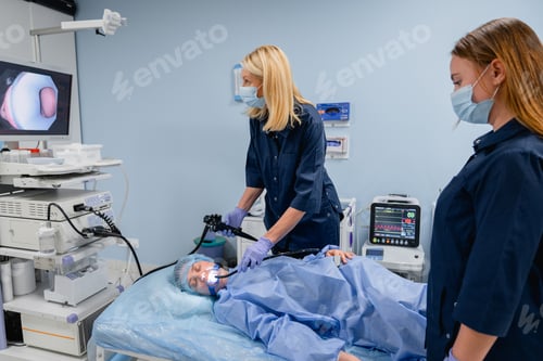 Preview: Professional endoscopy procedure with female patient and doctors in clinic, gastroscopy