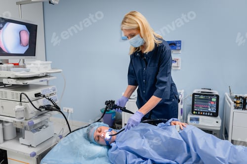 Preview: Doctor with woman patient during diagnostic endoscopy gastroscopy in hospital room