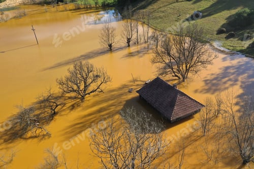 Preview: Aerial view choked sinking village house by acid mine drainage toxic waters