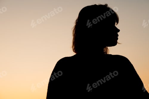 Preview: Silhouette of woman seen during sunset