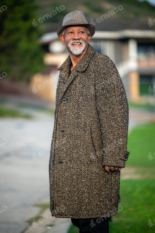 Preview: Senior man with coat seen standing outdoors