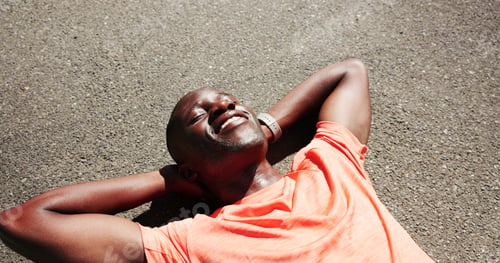Preview: Tired, fitness and above of black man in road for rest, recovery and relax for exercise