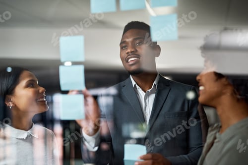 Preview: Man, sticky note and team by glass wall in office with writing, planning