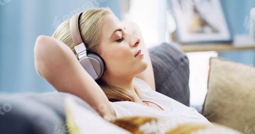 Preview: Eyes closed, headphones and relax with woman on sofa for streaming service