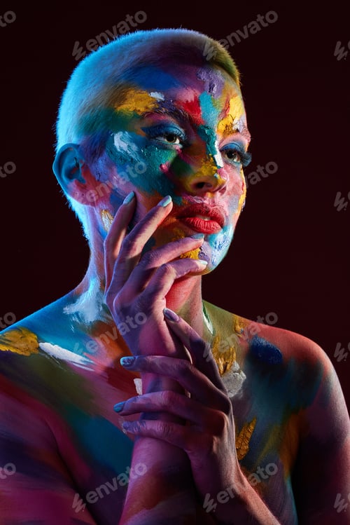 Preview: Woman, face paint and rainbow with touch in studio for beauty, art deco