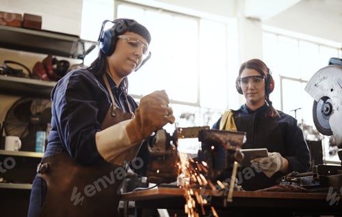 Preview: Women, grinder and PPE with team, metal work and manufacturing for maintenance and manual labor