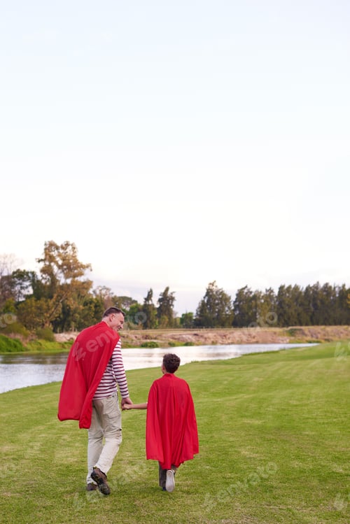Preview: Holding hands, superhero and back of father with child in nature for cosplay