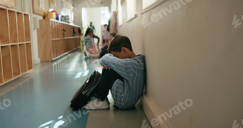 Preview: Boy, sad and depressed in corridor at school, alone and social isolation with mental health