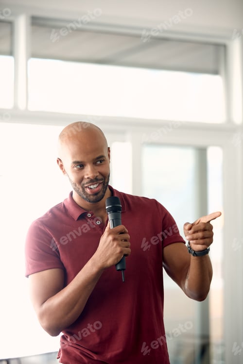 Preview: Speaker, talking and man with mic, presentation and speech for training session or smile in seminar