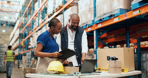 Preview: Logistics, team and clipboard with laptop in warehouse to track order, shipping status or feedback