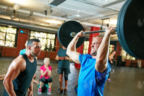 Preview: Man, barbell and personal trainer in gym for senior fitness, training and health for body strength