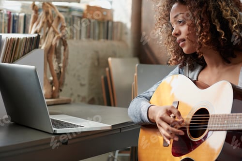 Preview: Songwriting, laptop and woman with guitar in home, creative and practice with social media