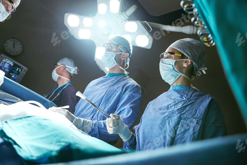 Preview: Surgeon, low angle and people in operating room, equipment and clinical support with lights