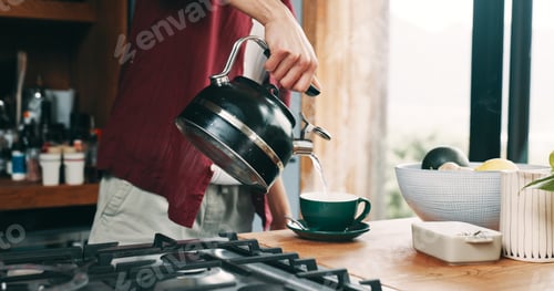 Preview: Hand, pouring tea and steam with person in kitchen of home for beverage preparation at counter