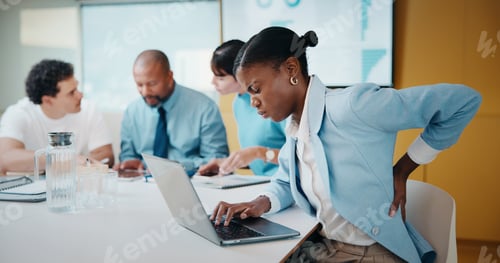 Preview: Woman, back pain and laptop in meeting at office with typing, injury and bad posture at finance