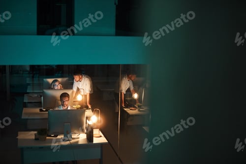Preview: Night, computer and coworking with business people in office for fact check, typing or review news