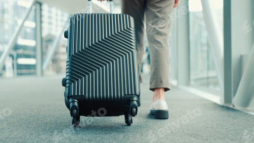Preview: Person, legs or travel with suitcase in airport for business journey, work trip or commute