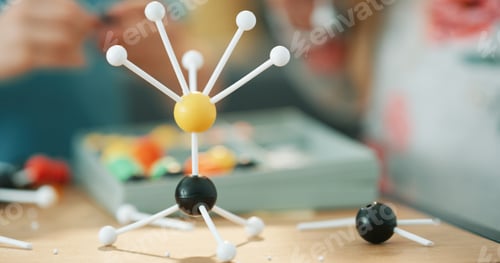 Preview: Project, science and person with atom model on desk for studying, education or assignment in house