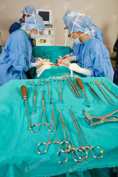 Preview: Team, surgery and patient in operating room at hospital, collaboration and trauma response on bed