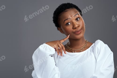 Preview: Portrait, thinking and black woman with pride in studio for vision, planning and sarcasm expression