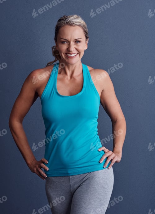Preview: Portrait, fitness and mature woman in studio with confidence, happiness and wellness