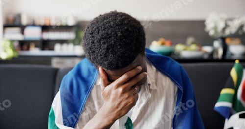 Preview: Man, stress and South Africa flag for soccer on couch with disappointment