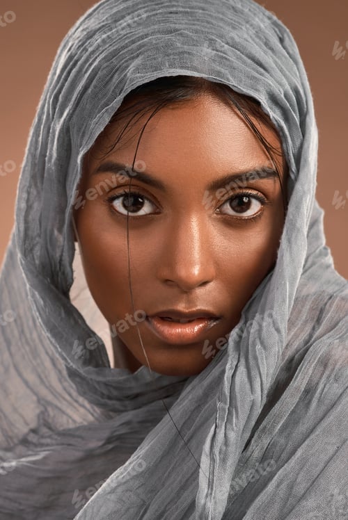 Preview: Muslim woman, portrait and scarf with beauty in studio for fashion or style on a brown background
