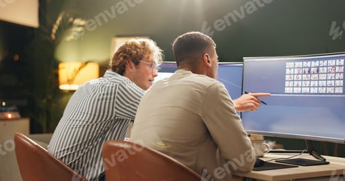 Preview: Night, creative and people in office with computer, image review and selection for digital