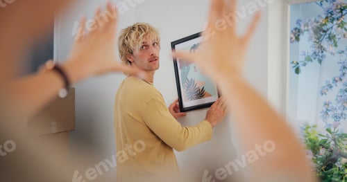 Preview: Hanging picture, measure and moving day with couple in new home together for interior design