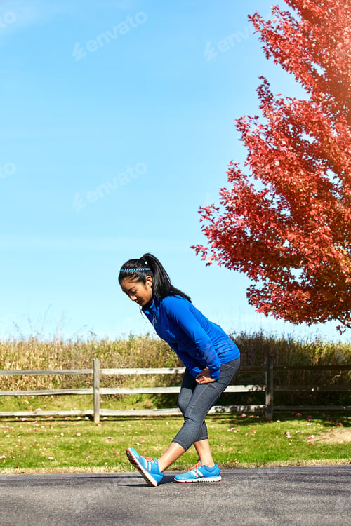 Preview: Runner, stretching and woman in park with earphones for exercise, training and workout for wellness