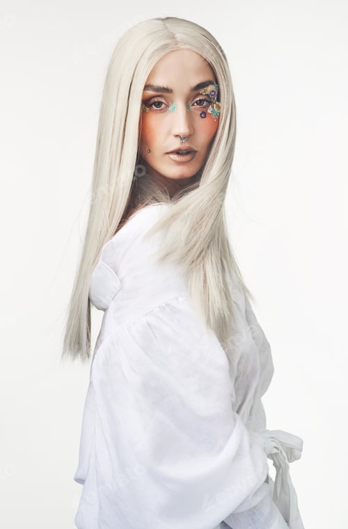 Preview: Portrait, flowers and aesthetic with woman in studio for makeup, sustainable fashion and beauty
