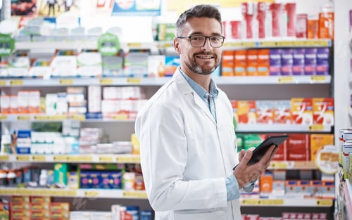Preview: Happy, pharmacist and portrait of man with tablet for stock, medicine sales and healthcare