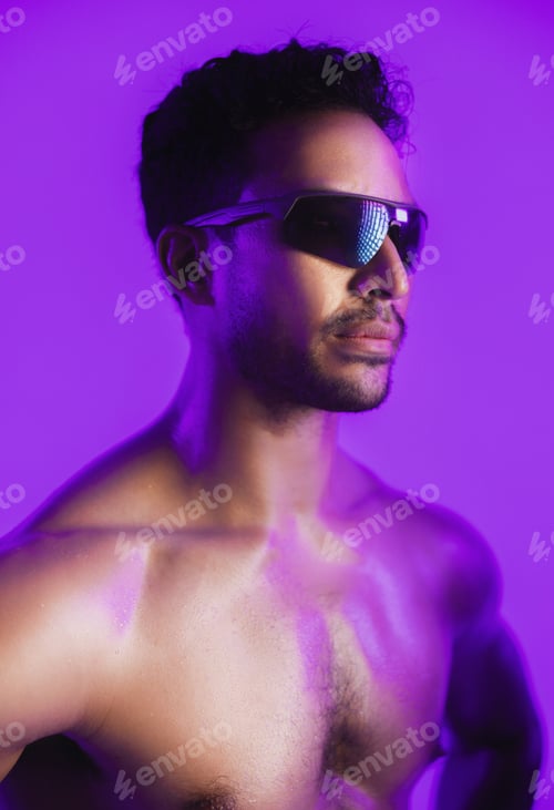 Preview: Man, sunglasses and topless in studio with bodybuilding, muscle or aesthetic on purple background