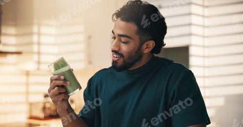 Preview: Happy, morning and man with smoothie in kitchen for healthy diet, nutrition and wellness