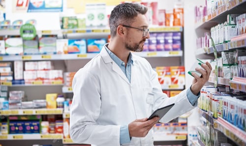 Preview: Box, pharmacist and man with tablet for stock check, medicine and healthcare inspection